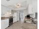 Modern kitchen featuring white cabinets, stainless steel appliances, and tile flooring at 10299 Willmington Blvd, Englewood, FL 34224