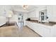 Well-lit kitchen with white cabinetry, tile flooring, and stainless steel appliances, offering ample counter space at 10299 Willmington Blvd, Englewood, FL 34224