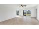 Bright living space showcasing tile flooring and sliding glass doors leading to the outdoor area at 10299 Willmington Blvd, Englewood, FL 34224