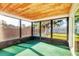 Cozy screened-in porch featuring wood ceiling and view of the backyard at 10299 Willmington Blvd, Englewood, FL 34224
