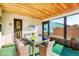 The Sunroom has a paneled ceiling, glass table and overlooks the outdoors at 10299 Willmington Blvd, Englewood, FL 34224