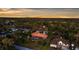 Aerial view of a home with an enclosed pool area surrounded by a canopy of trees at 103 Mecca St, Port Charlotte, FL 33954