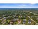 Expansive aerial view of a residential neighborhood with lush greenery and blue skies at 103 Mecca St, Port Charlotte, FL 33954