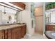 Bright bathroom boasts granite countertops, dual sinks, a tiled shower, and a separate vanity area at 103 Mecca St, Port Charlotte, FL 33954