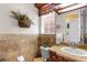 Well-lit bathroom with decorative wall accents, a sink, and a toilet, offering a functional and inviting space at 103 Mecca St, Port Charlotte, FL 33954