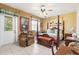 Comfortable bedroom featuring a four-poster bed, recliner, and outdoor access, providing relaxation and convenience at 103 Mecca St, Port Charlotte, FL 33954