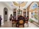 Formal dining room featuring coffered ceiling, large window, elegant chandelier, and seating for ten at 103 Mecca St, Port Charlotte, FL 33954
