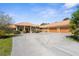 Beautiful home exterior with a spacious driveway leading to a three-car garage and lush landscaping at 103 Mecca St, Port Charlotte, FL 33954