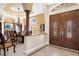 Foyer view featuring tile floors, decorative columns, and a glimpse into the dining room at 103 Mecca St, Port Charlotte, FL 33954