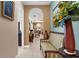 Inviting hallway with beige tiling, arched entryway, and decorated with elegant furniture and artwork at 103 Mecca St, Port Charlotte, FL 33954