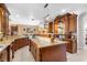 Spacious kitchen features custom wood cabinets, granite countertops, and stainless steel appliances at 103 Mecca St, Port Charlotte, FL 33954