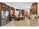 Chef's kitchen with granite counters, custom cabinets, stainless appliances, and tiled floor at 103 Mecca St, Port Charlotte, FL 33954