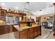Gourmet kitchen boasts wooden cabinets, granite countertops, and a kitchen island with bar seating at 103 Mecca St, Port Charlotte, FL 33954