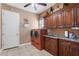 Functional laundry room with modern washer and dryer, ample cabinet space, and a convenient sink area at 103 Mecca St, Port Charlotte, FL 33954