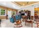 Comfortable living room with tile floors, a decorative ceiling, and an entertainment center with displayed pictures and decor at 103 Mecca St, Port Charlotte, FL 33954