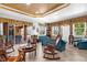 Bright living room featuring tile flooring, a decorative ceiling, and sliding glass doors leading to the outdoor pool area at 103 Mecca St, Port Charlotte, FL 33954