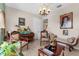 Neutral living room featuring classic chairs, an elegant chaise lounge, and a unique personalized piano at 103 Mecca St, Port Charlotte, FL 33954