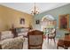 Cozy living room featuring a bay window, an elegant sofa, and is well-decorated with beautiful artwork at 103 Mecca St, Port Charlotte, FL 33954