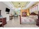 Beautiful main bedroom with floral bedding, light tile floors, and sitting area with TV at 103 Mecca St, Port Charlotte, FL 33954