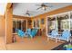 Inviting covered patio with outdoor seating, bar, and ceiling fans, perfect for relaxing and entertaining at 103 Mecca St, Port Charlotte, FL 33954