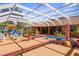 Spacious screened-in pool area with sun deck, outdoor seating, and lush landscaping offers a serene retreat at 103 Mecca St, Port Charlotte, FL 33954
