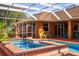Beautiful backyard pool with spa, screened enclosure, and ample patio space for outdoor enjoyment at 103 Mecca St, Port Charlotte, FL 33954