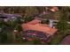 Back of house featuring a screened-in pool and beautifully landscaped yard at dusk at 103 Mecca St, Port Charlotte, FL 33954