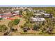 Aerial view of a single story home featuring a well-maintained lawn, mature landscaping, and a surrounding fence at 107 Jose Gaspar Dr, Englewood, FL 34223