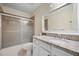 Bathroom featuring a granite-topped vanity, enclosed glass shower and toilet at 107 Jose Gaspar Dr, Englewood, FL 34223