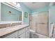 Bright bathroom featuring a granite-topped vanity and enclosed glass shower at 107 Jose Gaspar Dr, Englewood, FL 34223