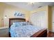 Bright bedroom with queen bed and matching bedside table and spacious closet at 107 Jose Gaspar Dr, Englewood, FL 34223
