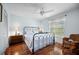 Light-filled bedroom with hardwood floors, ceiling fan and windows at 107 Jose Gaspar Dr, Englewood, FL 34223