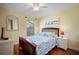 Comfortable bedroom with queen bed, ceiling fan, and light yellow walls at 107 Jose Gaspar Dr, Englewood, FL 34223