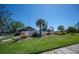 Community clubhouse in Gasparilla featuring ramp access, verdant lawn and meticulous landscaping at 107 Jose Gaspar Dr, Englewood, FL 34223