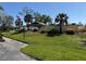 Community center features meticulously manicured lawn and landscaping, with a white picket fence at 107 Jose Gaspar Dr, Englewood, FL 34223