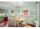 Inviting dining area with a charming chandelier and a pass-through view to the kitchen, enhancing connectivity at 107 Jose Gaspar Dr, Englewood, FL 34223