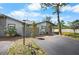 Well-kept home featuring green lawns, mature trees, and a paved driveway at 107 Jose Gaspar Dr, Englewood, FL 34223