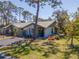 Exterior view of a lovely townhome surrounded by lush greenery at 107 Jose Gaspar Dr, Englewood, FL 34223