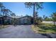 Charming single-story home featuring a private driveway and lush front yard landscaping at 107 Jose Gaspar Dr, Englewood, FL 34223