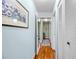 Hallway boasts hardwood floors, fresh paint, and a decorative floral print at 107 Jose Gaspar Dr, Englewood, FL 34223