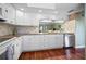 Bright kitchen showcasing granite counters, tile backsplash, stainless steel appliances and ample cabinet space at 107 Jose Gaspar Dr, Englewood, FL 34223