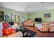 Cozy living room area with access to a screened lanai at 107 Jose Gaspar Dr, Englewood, FL 34223