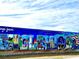 Colorful 'Englewood' mural with images depicting local scenes and landmarks on a building wall at 107 Jose Gaspar Dr, Englewood, FL 34223