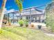 A large screened-in lanai covers the pool and backyard of this charming home at 12605 Bacchus Rd, Port Charlotte, FL 33981
