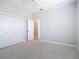 Bedroom features neutral carpet, bi-fold door closet, and gray walls at 12605 Bacchus Rd, Port Charlotte, FL 33981