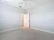Neutral bedroom with plush carpeting, and access to two closets at 12605 Bacchus Rd, Port Charlotte, FL 33981
