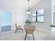 Cozy breakfast nook with rattan chairs, tile floors, and a view of the backyard at 12605 Bacchus Rd, Port Charlotte, FL 33981