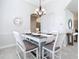 The light and bright dining room features stylish chandelier and lots of natural light at 12605 Bacchus Rd, Port Charlotte, FL 33981