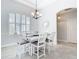 Bright dining room with a modern chandelier, plantation shutters, and neutral decor at 12605 Bacchus Rd, Port Charlotte, FL 33981