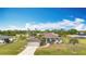 Charming home with well-manicured front lawn and a two-car garage at 12605 Bacchus Rd, Port Charlotte, FL 33981